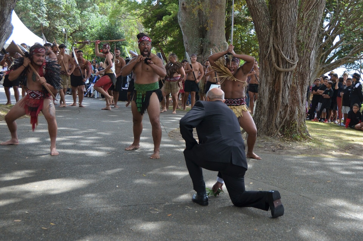 Maori dancers in traditional attire performing a cultural ritual