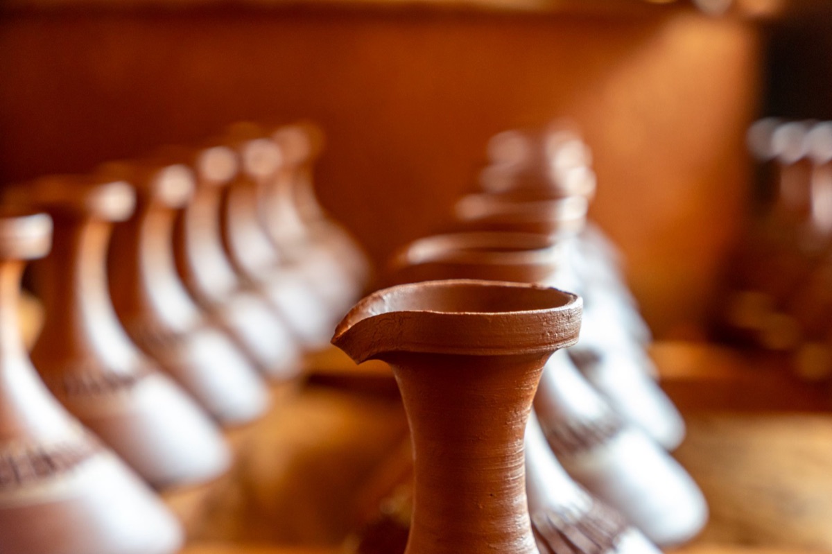 Maori artisan crafting traditional artifacts in a workshop