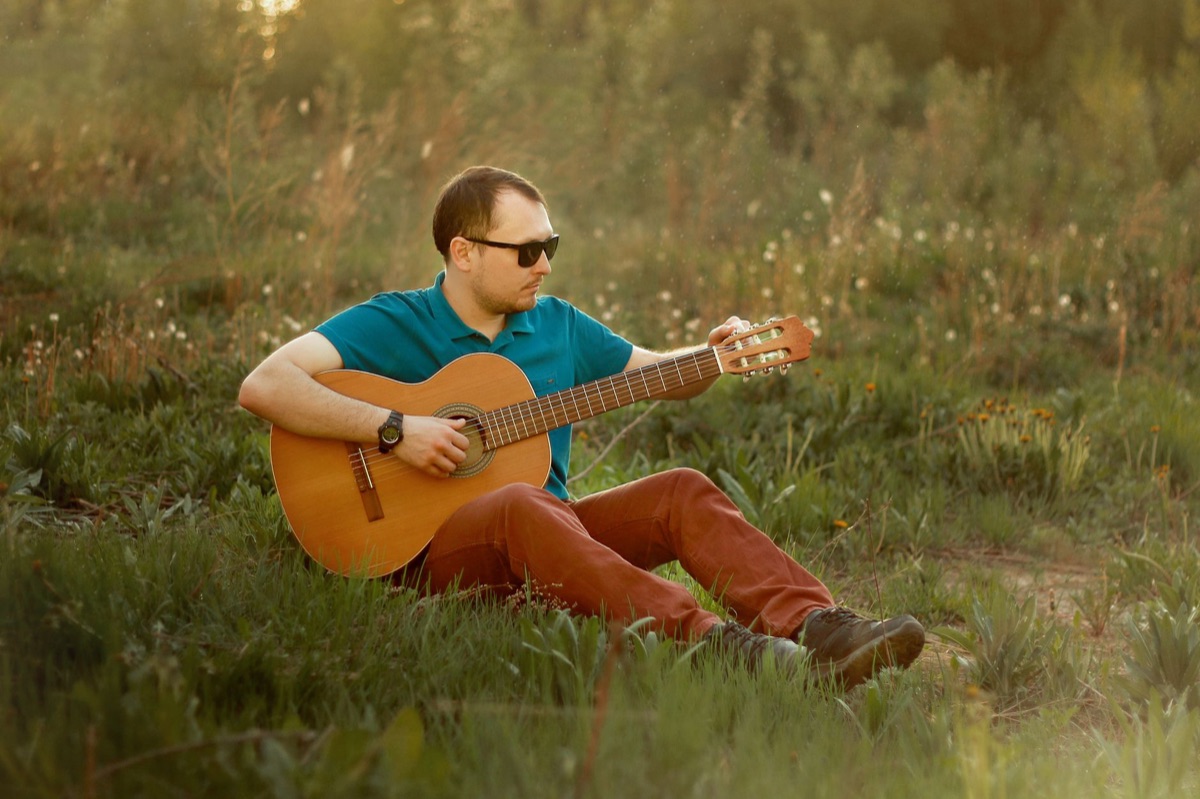 Guitarist playing in natural setting in New Zealand