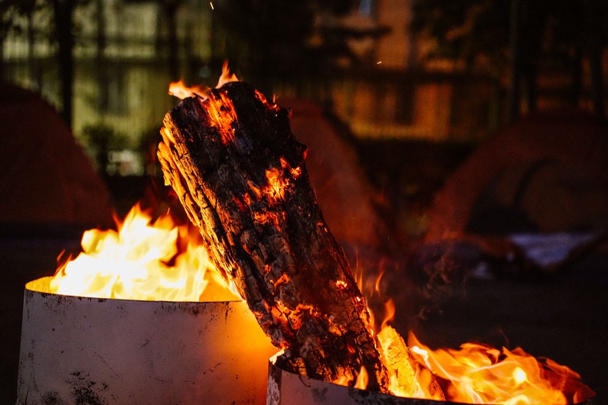 maori cultural campsite with fire and teepee